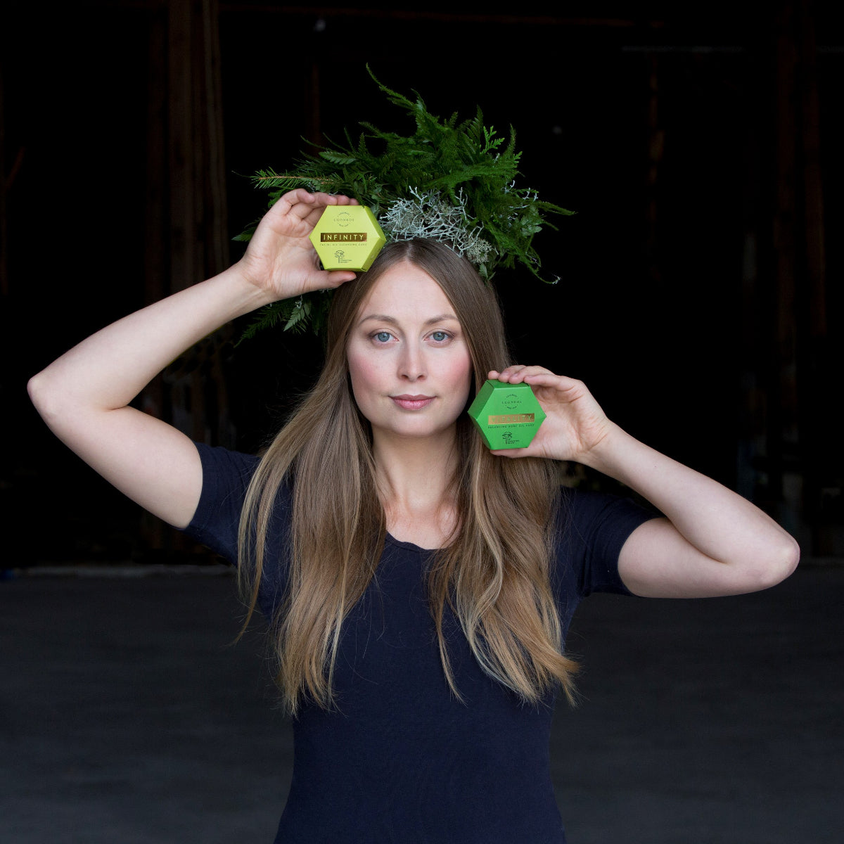 Woman holding Oil Cleansing Cake, showcasing natural facial cleanser.