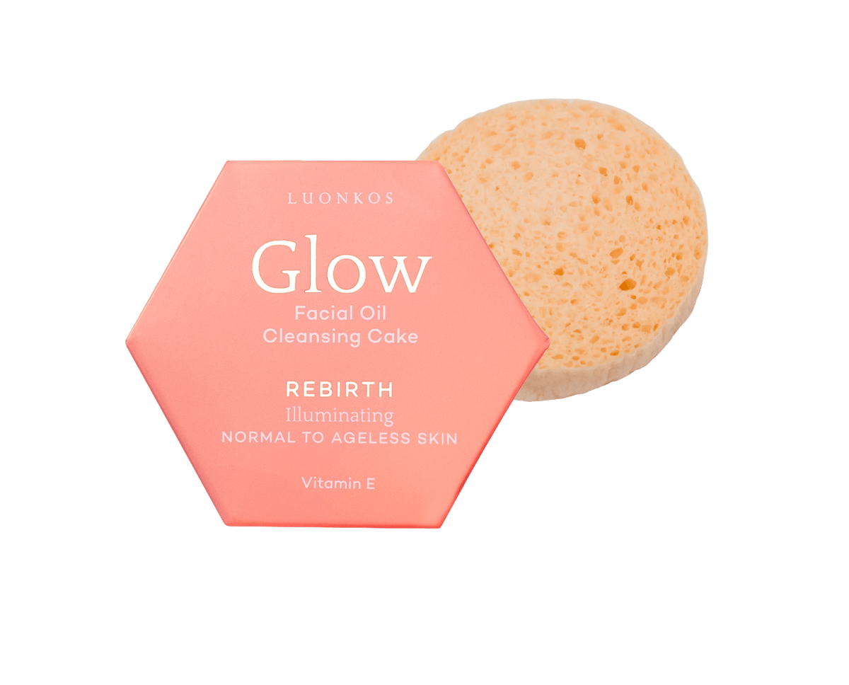 Luonkos Glow Rebirth öljypuhdistuskakku vaaleanpunaisessa kuusikulmaisessa pakkauksessa ja ekologinen kasvosieni